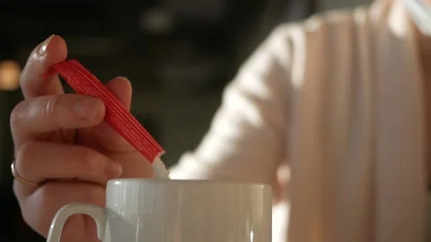 Adding sugar to freshly brewed cappuccino coffee in a restaurant. Stock Footage 144555675