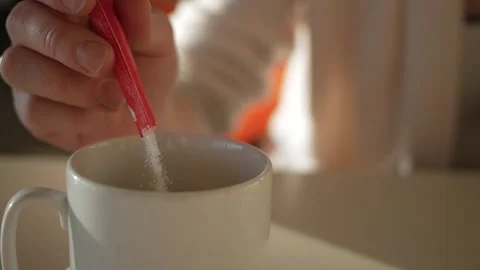 Adding sugar to freshly brewed cappuccino coffee in a restaurant. Stock Footage 144555682