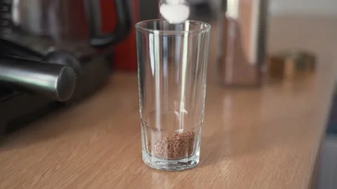 Adding sugar in a glass, making instant coffee Stock Footage 139093387