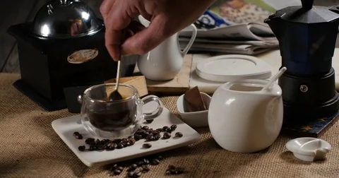 Adding sugar to a hot cup of coffee from a traditional Italian coffee machine Stock Footage 74067823