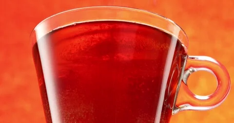 Adding Sugar In Tea Cup. Pouring Sugar Into Tea with spoon. Stock Footage 242590500