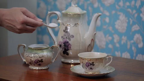 Adding sugar in the tea during breakfast preparation Stock Footage 153981368