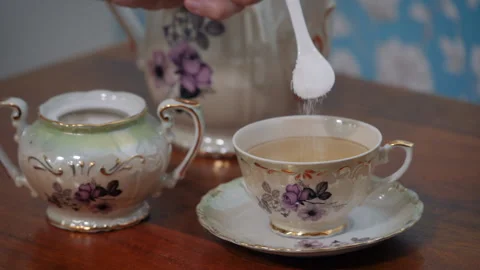 Adding sugar in the tea during breakfast preparation Stock Footage 153982289