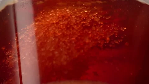 Adding sugar to tea. grains of sugar in liquid. macro shot. Stock Footage 244131894