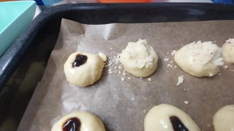 Adding Sweet Crumble Topping to Raw Dough Buns with Plum Jam moravian Stock Footage 333642222