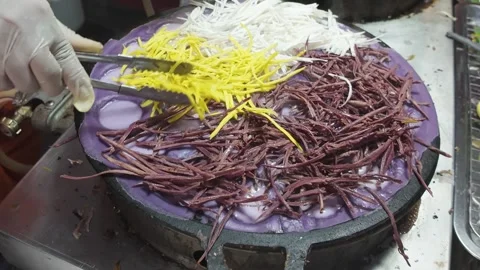 Adding Sweet Potato and Coconut Filling to Purple Pancake Batter Stock Footage 327841664