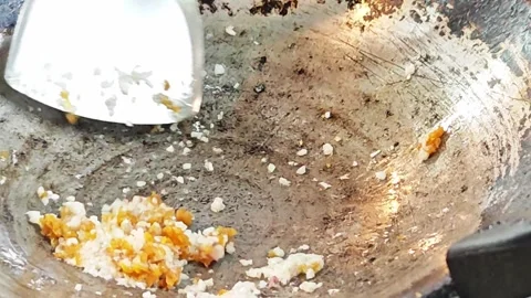 Adding sweet preserved radish to minced garlic in a hot wok. Video stock 342403041