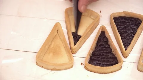 Adding tasty chokolate to the small tarts Stock Footage 74470750