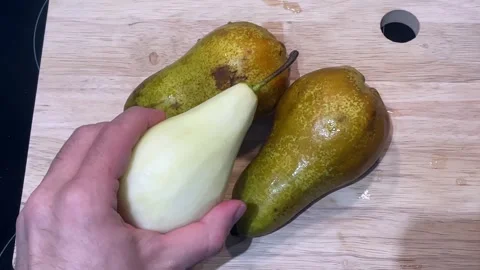 Adding the third pear to the cutting board Stock-Footage 329623020