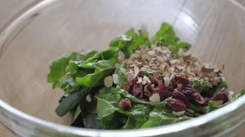 Adding toasted almonds to salad with blueberries Stock Footage 85130790