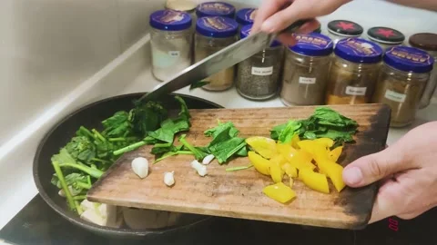 Adding tofu, vegetables and tomato to hot pan - Healthy home cooking Video stock 138586902