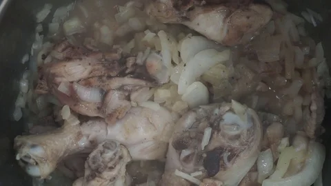 Adding tomato to braised chicken overhead Stock Footage 121118528