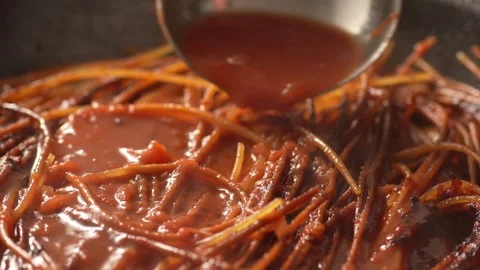 Adding tomato broth while frying pasta. Stock Footage 263757964