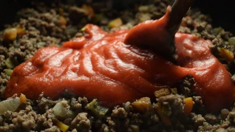 Adding tomato puree to minced meat Stock Footage 122611335