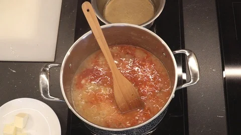 Adding tomato puree to rice overhead Stock Footage 112127770