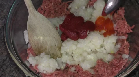 Adding tomato puree, salt,  pepper and sauce Stock Footage 46987396