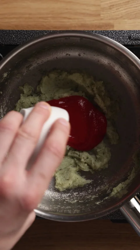 Adding Tomato Puree to Sauteed Onions Overhead View Видео 329889051