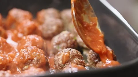 Adding tomato sauce to a delicious small meatballs. Stock Footage 151046365