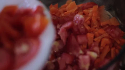 Adding tomatoes to pan with carrots Stock Footage 35221561