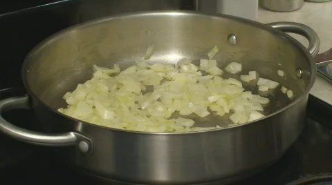 Adding tomatoes to sauting onions Stock Footage 662806