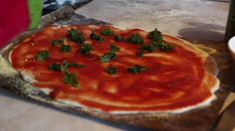 Adding toppings to a  homemade pizza Stock Footage 45500958
