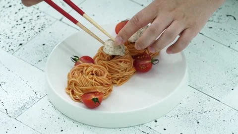 Adding Toppings to Korean Bibim Noodles with Chopsticks Stock Footage 334280082
