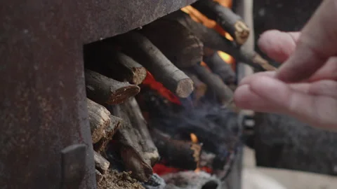 Adding tree branch in blazing fire 4K sl... | Stock Video | Pond5