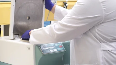 Adding tubes in centrifuge machine Stock Footage 113477420