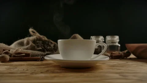 Adding two cane sugar cubes into coffee or tea cup by hand with splash Stock Footage 137090684