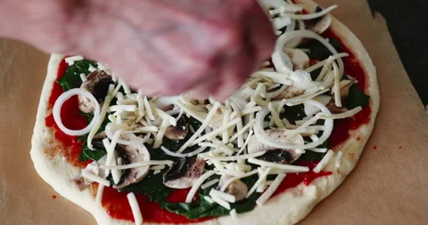 Adding vegan cheese to home made pizza Stock Footage 241607039