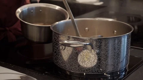 Adding vegetable broth to rice Stock Footage 112127074