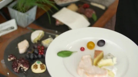 Adding vegetables to a Cheese platter Video stock 79654024