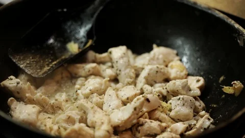 Adding vegetables to chicken Stock Footage 98361611