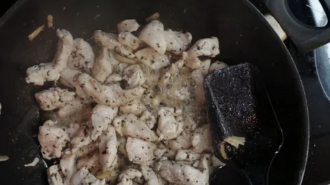 Adding vegetables to chicken overhead Stock Footage 98361040