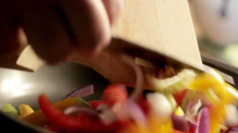 Adding vegetables to pan on stove, cooking in kitchen Stock Footage 23137065