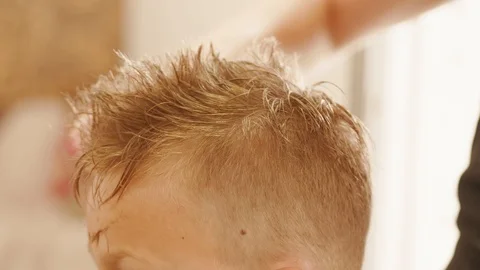 Adding volume to hair by barber scissors, combing teens hair Stock Footage 115659980