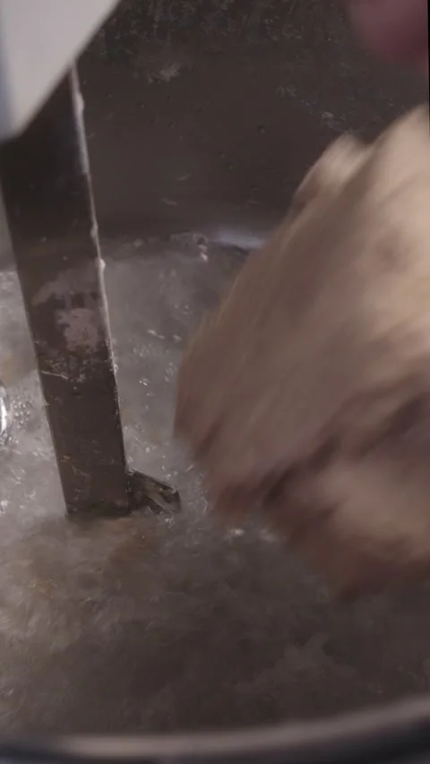 Adding Water and Dough to an Industrial Mixer Stock Footage 345062347