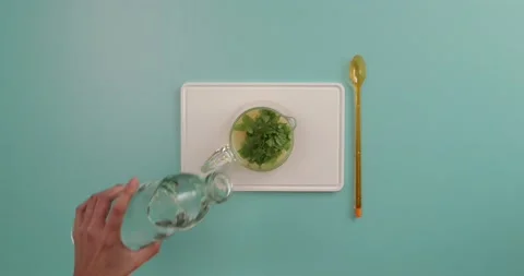 Adding water and ice to a lemonade Stock Footage 132149684