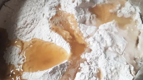 Adding Water and Ragi Flour to Boiling Mixture for Dough Preparation Video stock 334026544