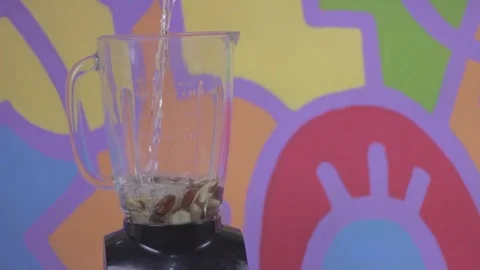 Adding water to a blender full of brazil nuts Stock Footage 79537001