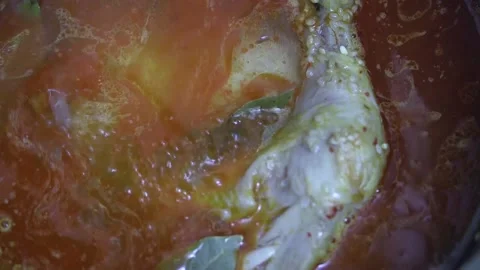 Adding water to the cauldron where amateur pilaf with chicken leg begins to Vídeos de archivo 220957680