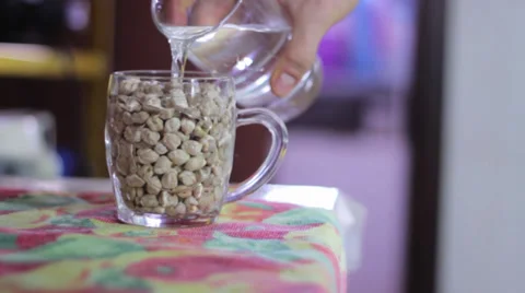 Adding water to chickpeas on a mug Stock Footage 35223817