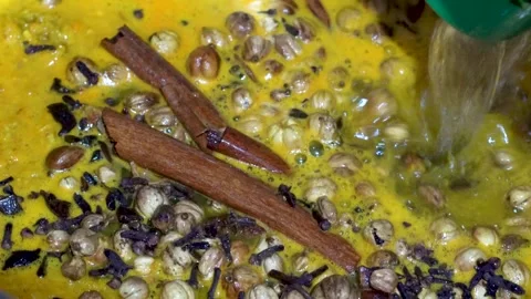 Adding Water to Cooking Spices for Curry and Stew Preparation Stock Footage 342344721