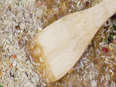 Adding water to dry beef flavored rice mix in a pan. Stock Footage