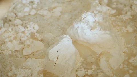 Adding Water to Flour for Bread Dough Stock Footage 129717030