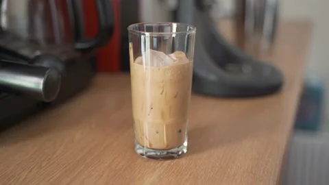 Adding water to make iced instant coffee (frappe) Stock Footage 139092599