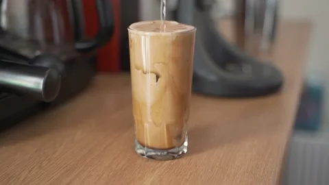 Adding water to make iced instant coffee (frappe) Stock Footage 139093248