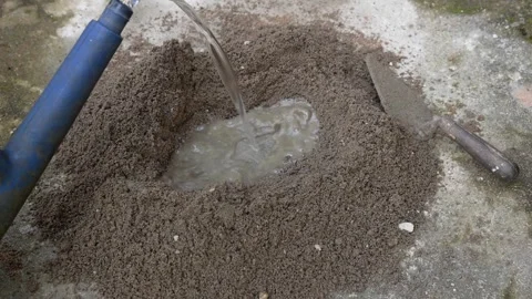 Adding water to mortar or cement mixture Stock Footage 300930085