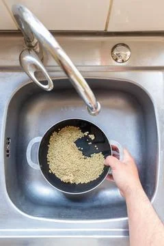 Adding water to a pot with lentils Stock Photos