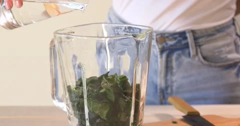 Adding water to smoothie Stock Footage 148185128